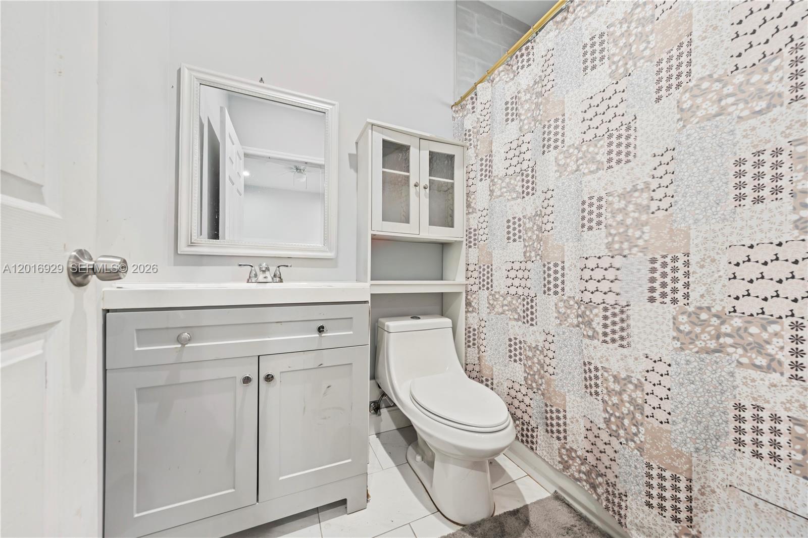 4721 Northwest 15th Court, Unit 1 Miami, FL 33142 - Photo 11 of 11 a bathroom with a toilet a sink and a shower