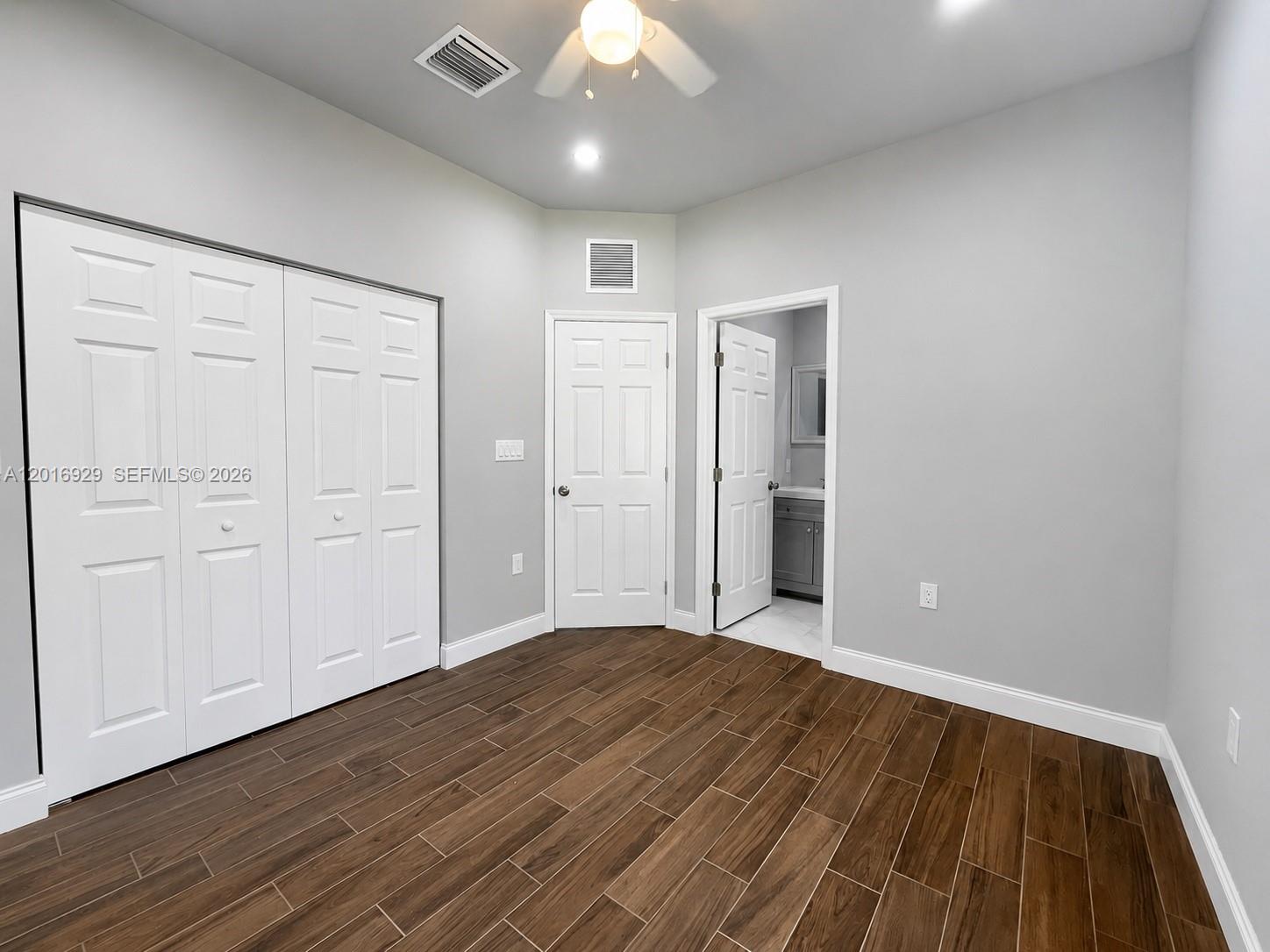 4721 Northwest 15th Court, Unit 1 Miami, FL 33142 - Photo 7 of 11 a view of an empty room with wooden floor
