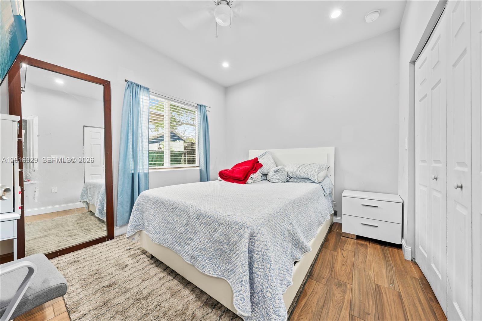 4721 Northwest 15th Court, Unit 1 Miami, FL 33142 - Photo 9 of 11 a bedroom with a bed and a large window