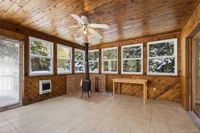 a view of a livingroom with wooden floor window and a kitchen