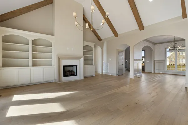 a large kitchen with stainless steel appliances a large center island wooden floor and a wooden floors