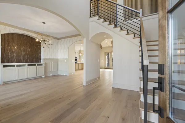 a view of entryway and hall with wooden floor