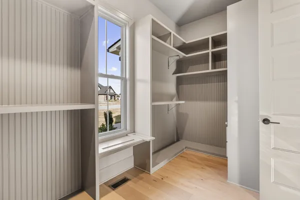 a view of a kitchen with white cabinets