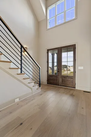 an empty room with wooden floor and fireplace