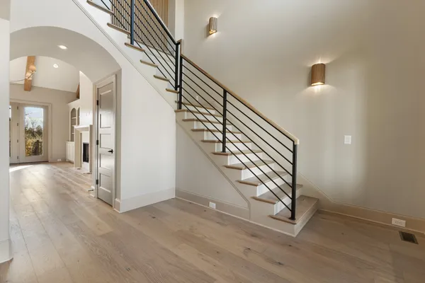 a view of an empty room with a fireplace and a window