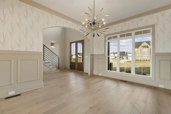 a view of a livingroom with kitchen and a large window