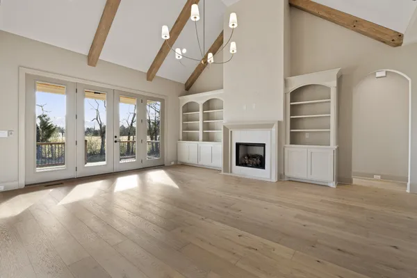 a large kitchen with granite countertop a stove oven and a large window