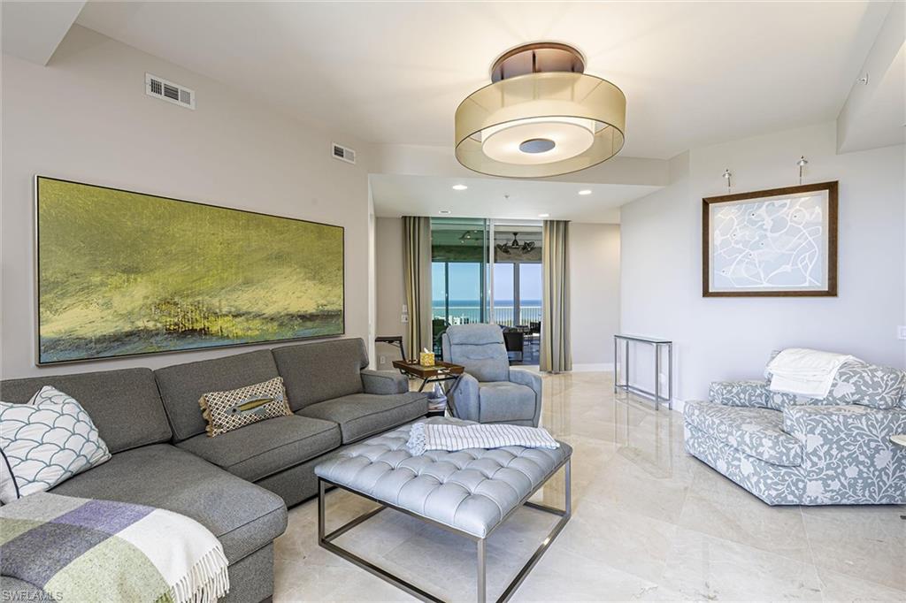 295 Grande Way, Unit PH2 Naples, FL 34110 - Photo 12 of 45 a living room with furniture and a large window