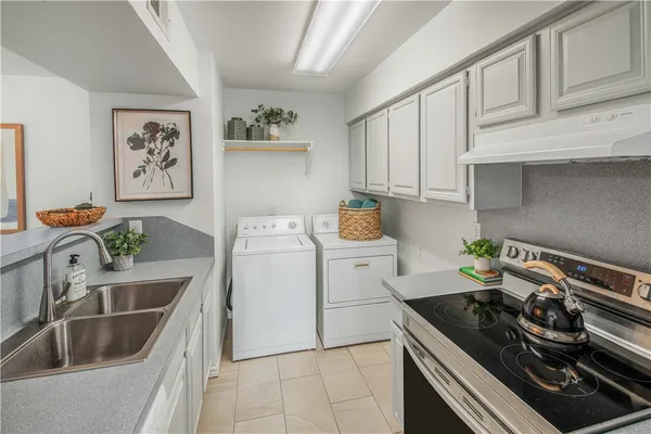 a kitchen with a sink stove and cabinets