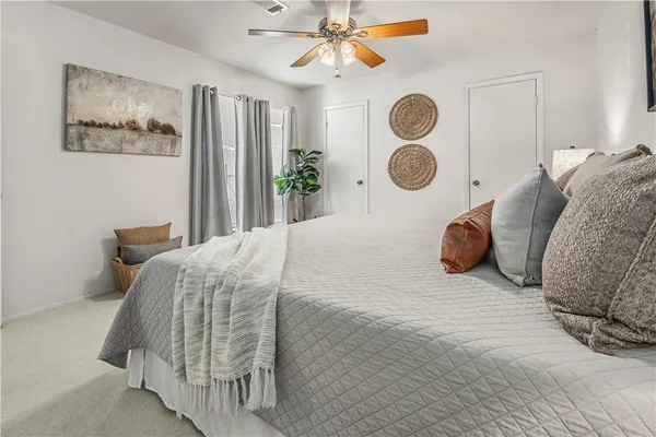 a bedroom with a bed and a window