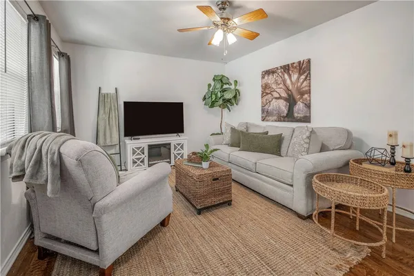 a living room with furniture and a flat screen tv