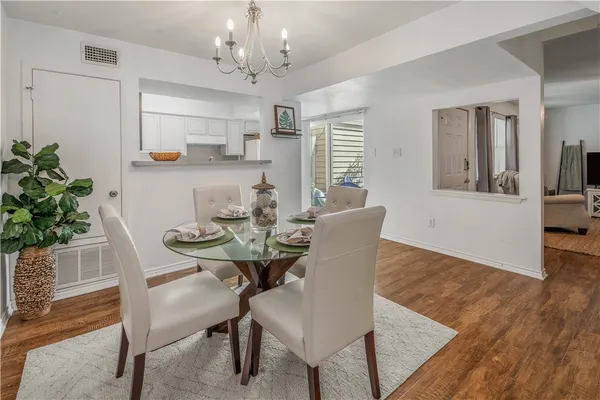 a view of a dining room with furniture and wooden floor