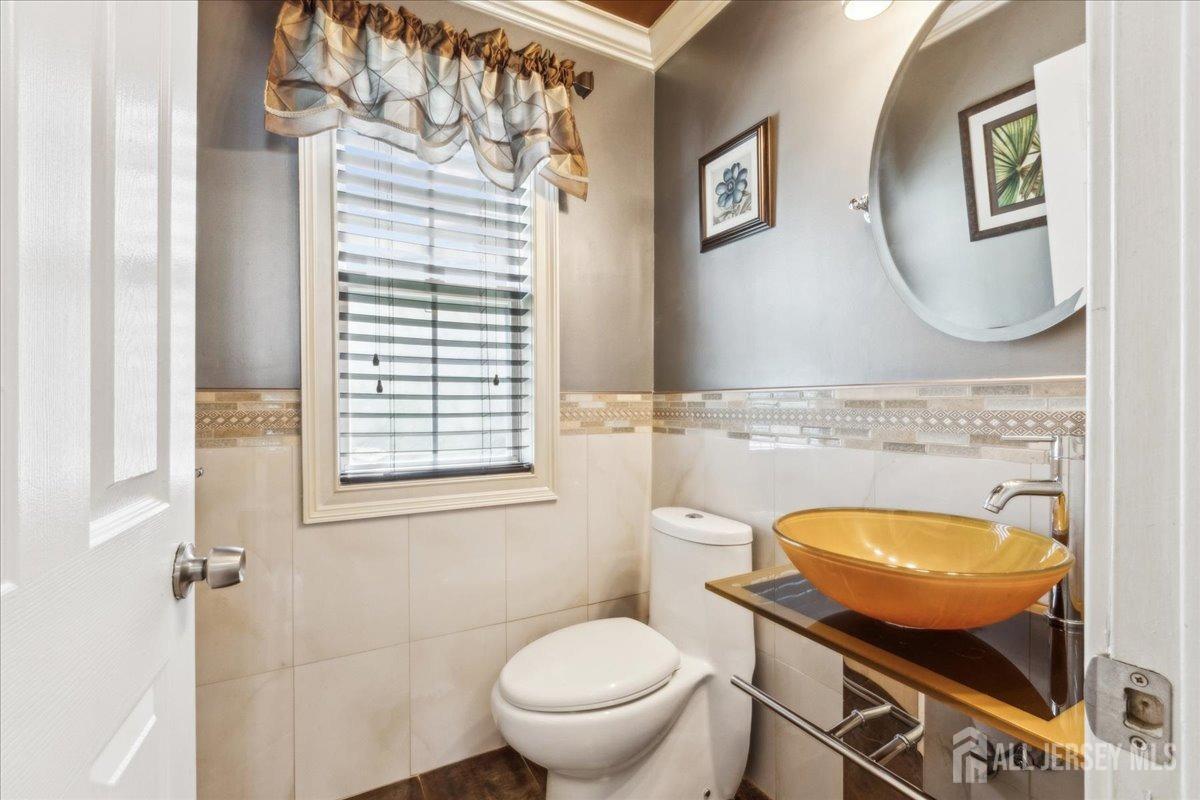 34 Crescent Road Old Bridge, NJ 08857 - Photo 15 of 34 a bathroom with a toilet a sink and a mirror