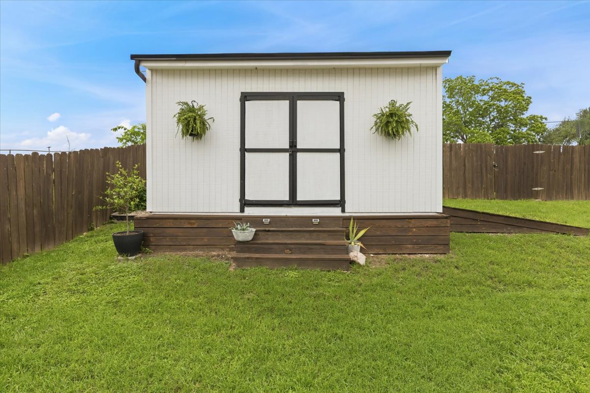 208 Skyloop Drive Austin, TX 78745 - Photo 27 of 34 Detached storage shed with modern exterior design and convenient backyard access.