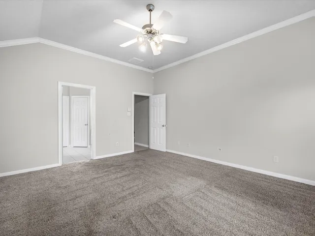 a view of an empty room with a ceiling fan