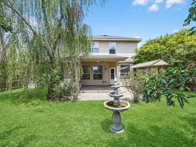 a view of a house with backyard sitting area and garden