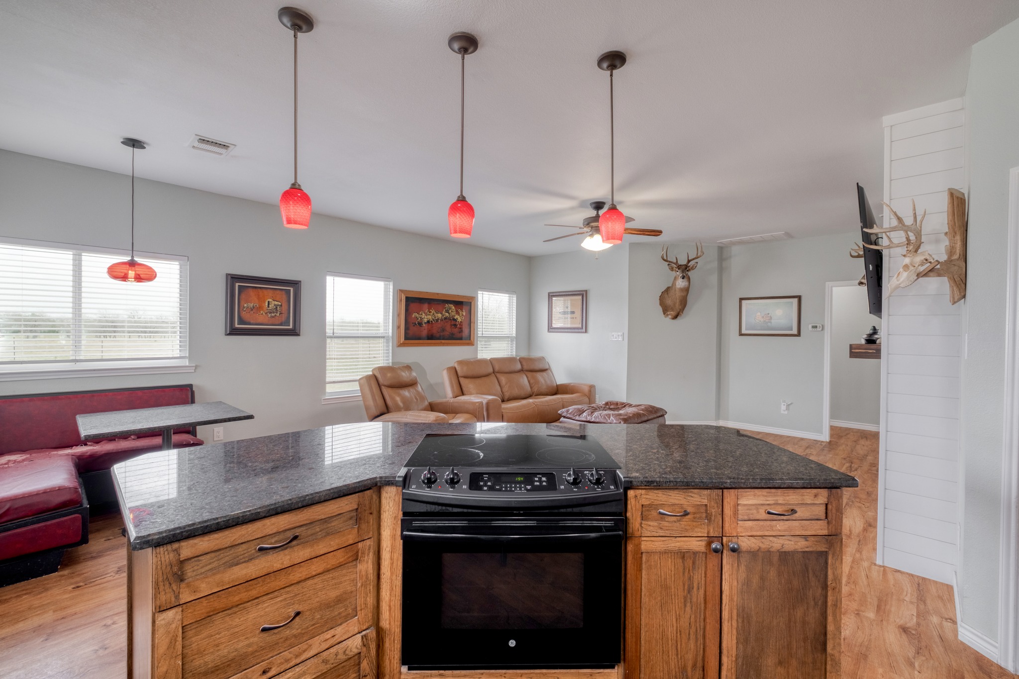 2950 County Road 484 Elgin, TX 78621 - Photo 25 of 25 Kitchen with open floor plan, black electric range oven, ceiling fan, and wood finish cabinets
