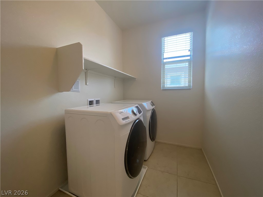 436 Cadence View Way Henderson, NV 89011 - Photo 31 of 36 Functional laundry room offers a convenient layout with available shelving and natural light.