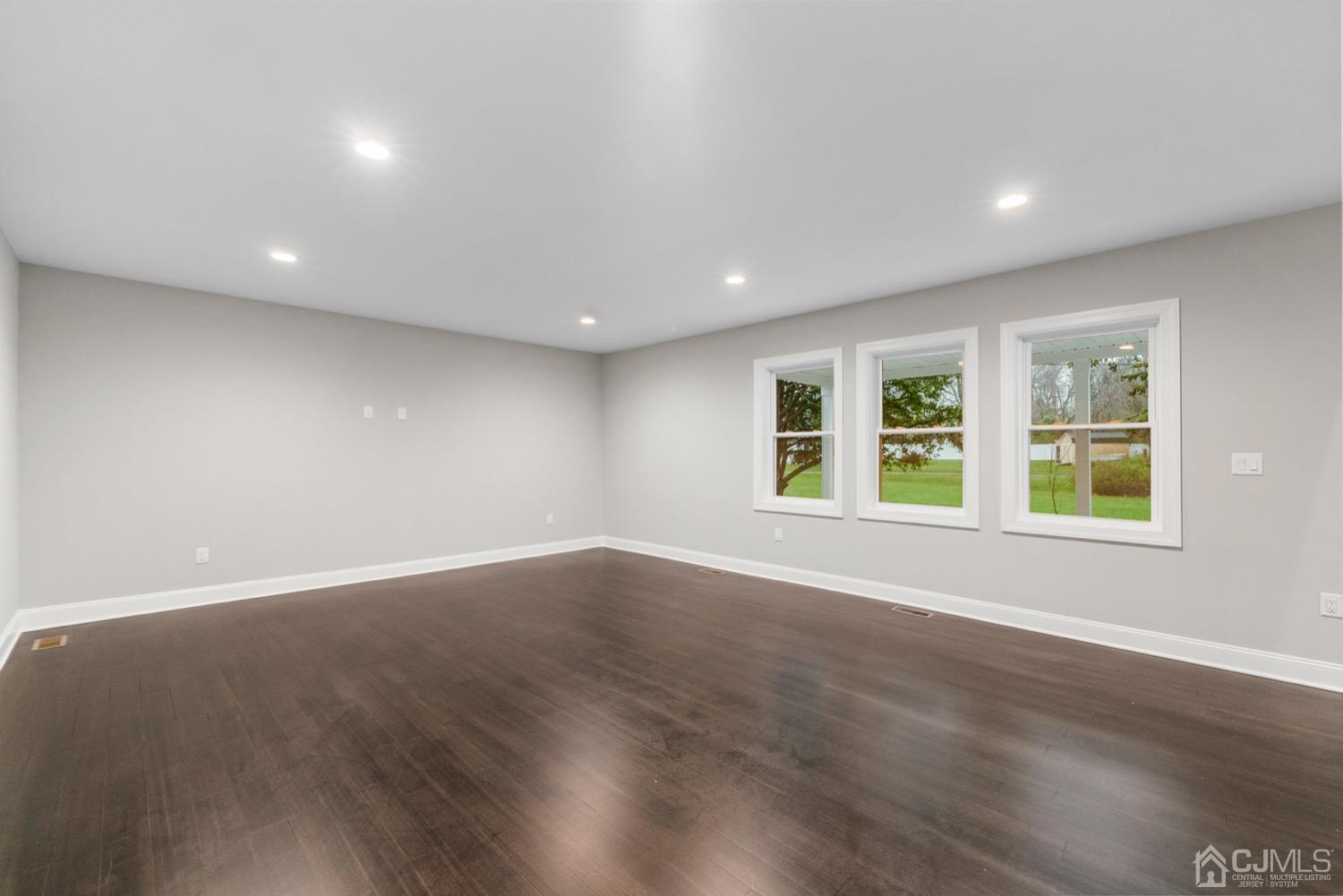 20 Old Ridge Road Monmouth Junction, NJ 08852 - Photo 9 of 26 a view of an empty room with wooden floor and windows