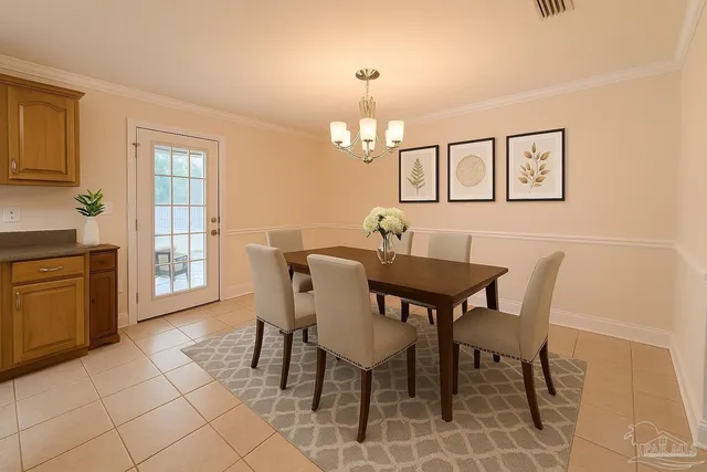 a view of a dining room with furniture and chandelier