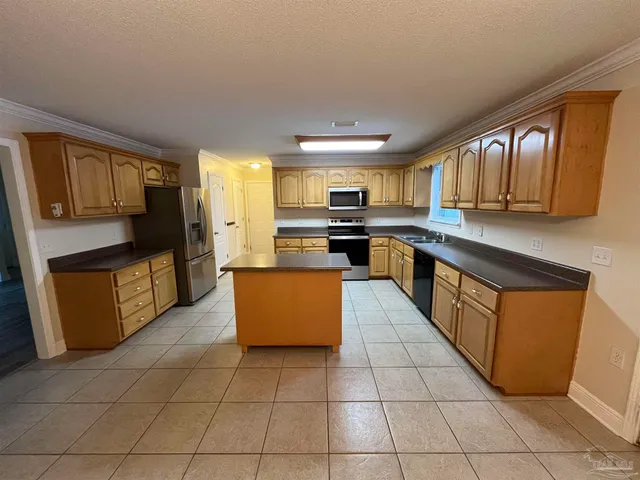 a kitchen with stainless steel appliances granite countertop a stove top oven a sink a counter top space and cabinets