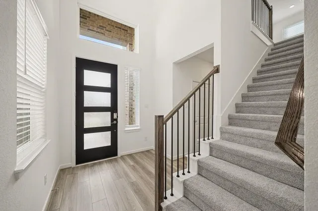 a view of staircase with white walls and windows