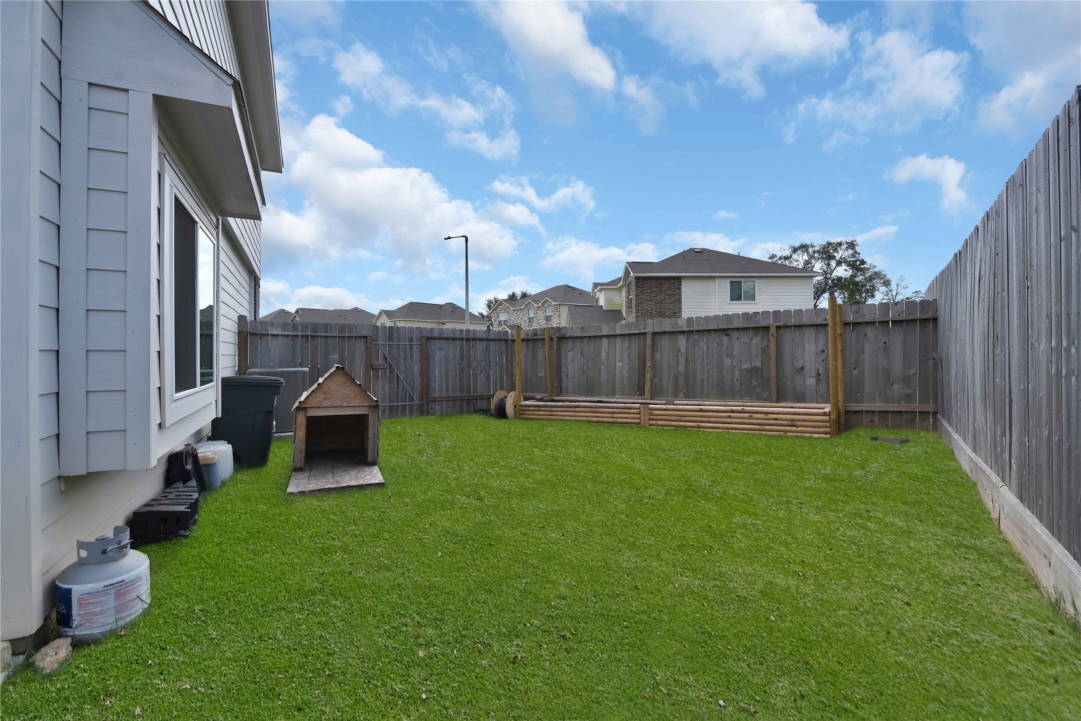 17703 Lion Heart Road Conroe, TX 77306 - Photo 25 of 26 a view of a backyard with sitting area