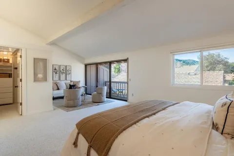 a bedroom with a large bed and a window