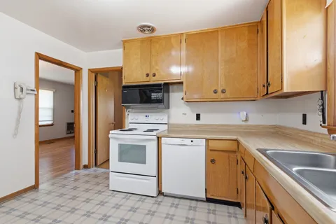 a kitchen with a sink stove and cabinets