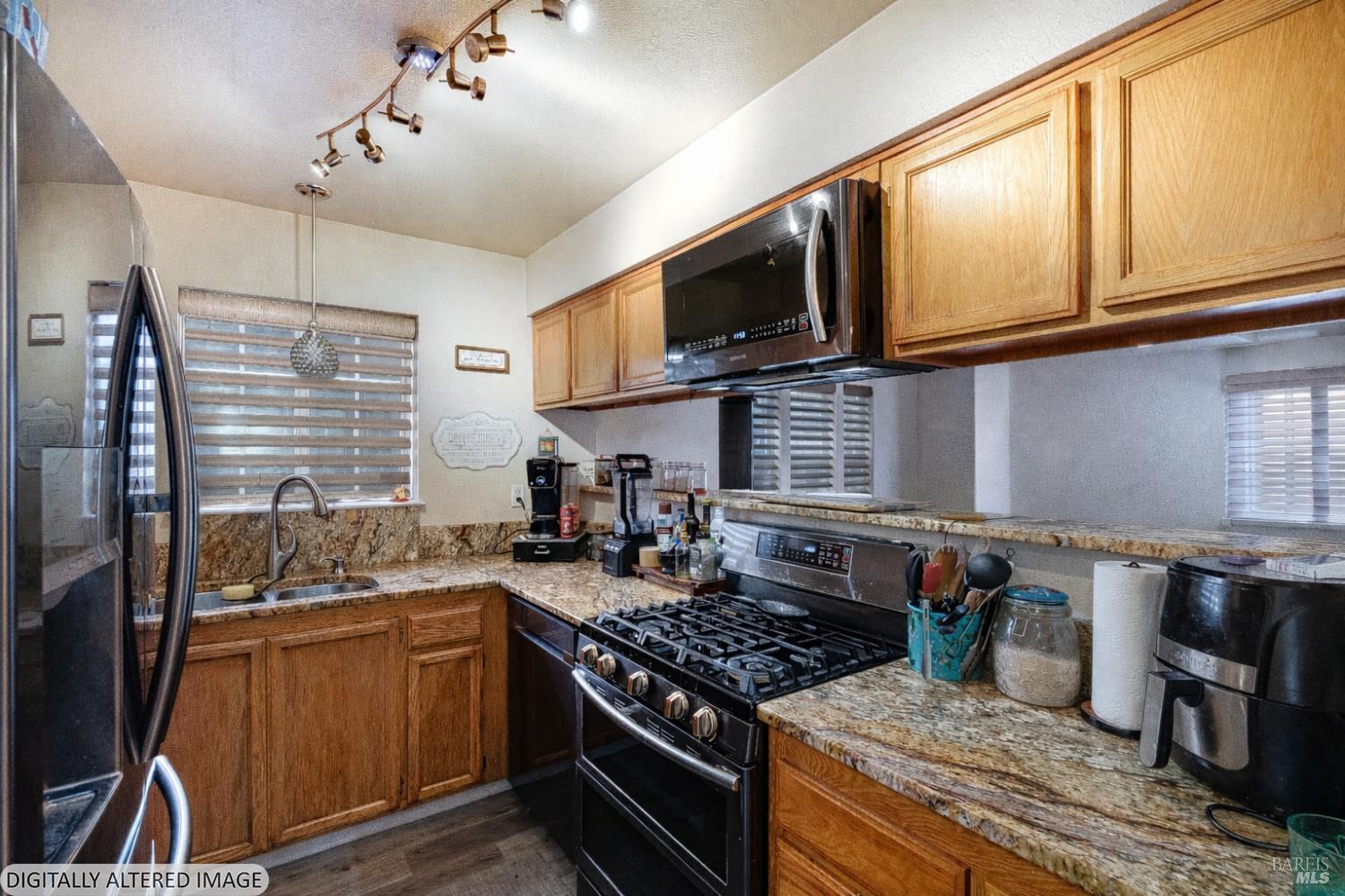 590 Laurel Grove Circle Santa Rosa, CA 95407 - Photo 11 of 44 a kitchen with stainless steel appliances granite countertop a stove and a microwave
