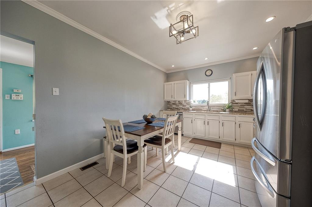 31 Diebold Road McKees Rocks, PA 15136 - Photo 10 of 25 a kitchen with cabinets and chairs