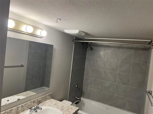 a bathroom with a sink and shower
