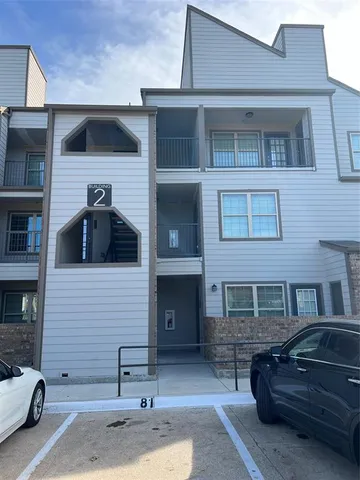 a front view of a house with parking space