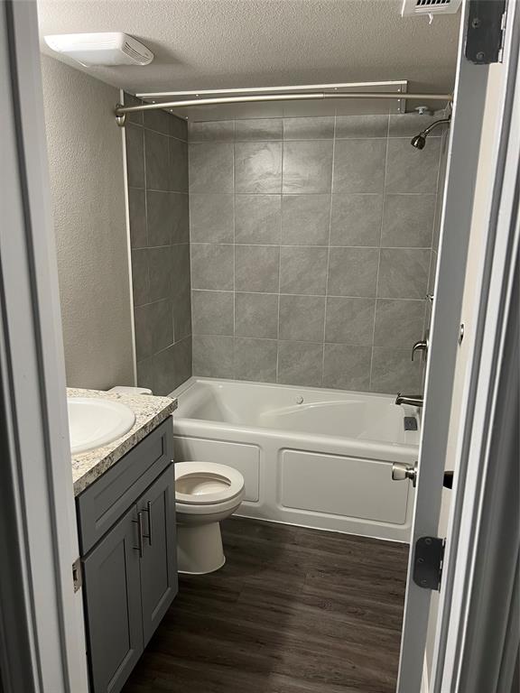 6108 Abrams Road, Unit 225 Dallas, TX 75231 - Photo 15 of 15 a bathroom with a granite countertop bathtub shower sink vanity and toilet