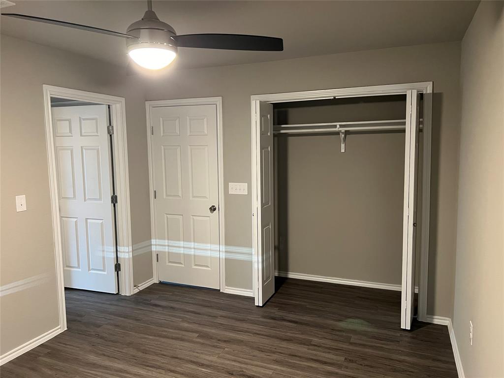 6108 Abrams Road, Unit 225 Dallas, TX 75231 - Photo 5 of 15 an empty room with wooden floor & closet area