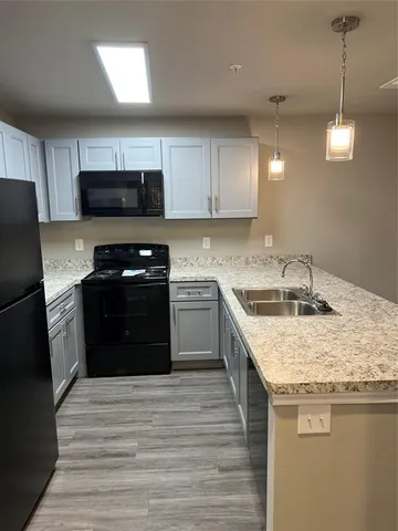 a kitchen with a sink a stove and refrigerator