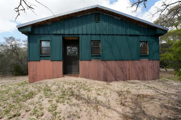 a view of a room with furniture and windows