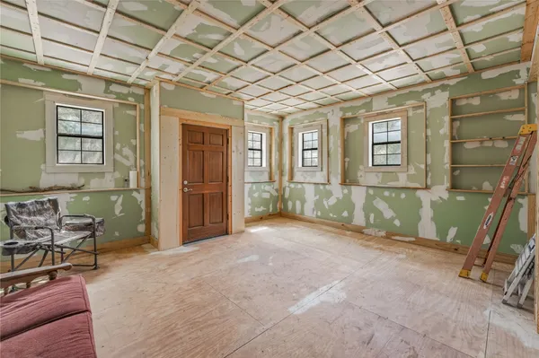 a view of a porch with furniture and a backyard