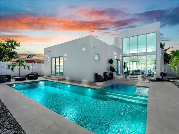 a swimming pool with outdoor seating and yard