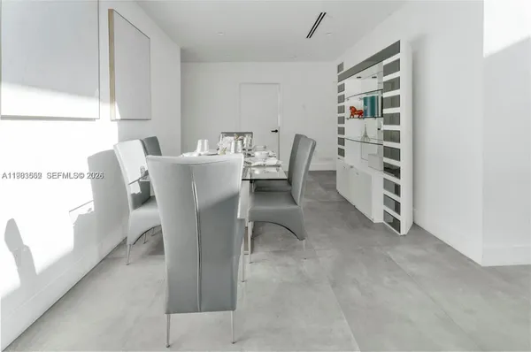 a dining room with furniture and a window