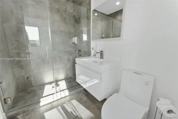 a bathroom with a sink toilet and shower