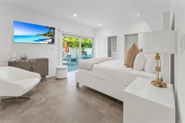 a bedroom with a bed and a couch