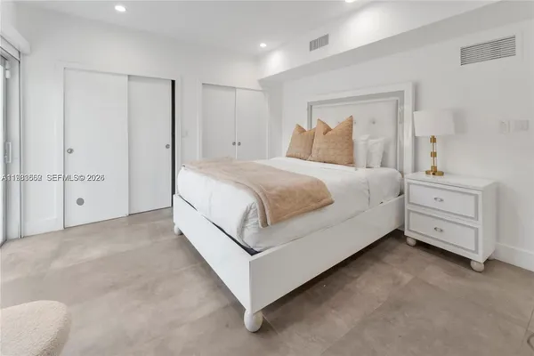 a large white bed in a white room