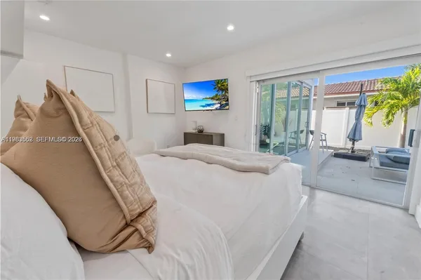 a bedroom with a bed and a large window