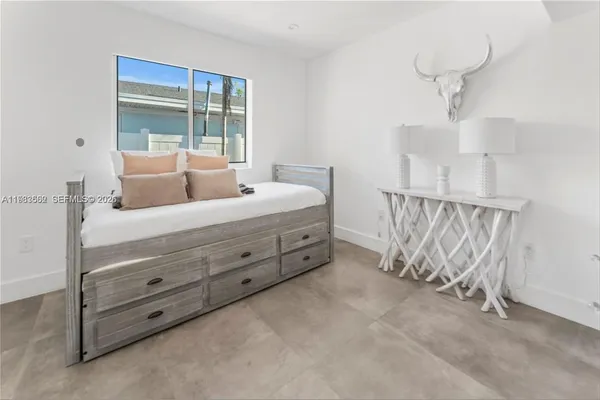 a room with a bed and a chandelier