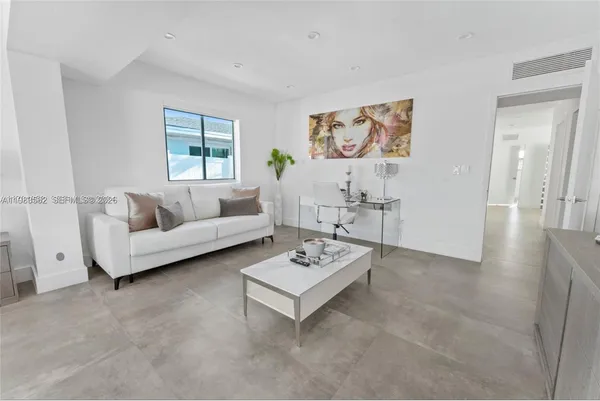 a spacious bedroom with a bed and large window