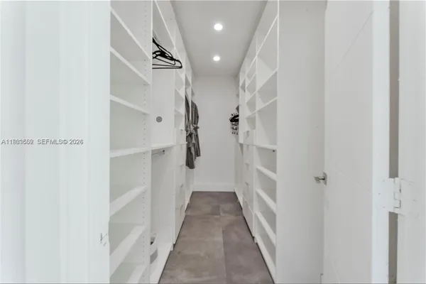 a en suite bathroom with a tub sink mirror and toilet