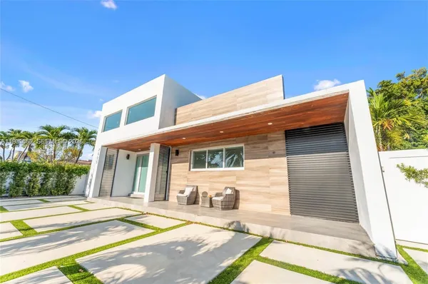 a front view of a house with a garden