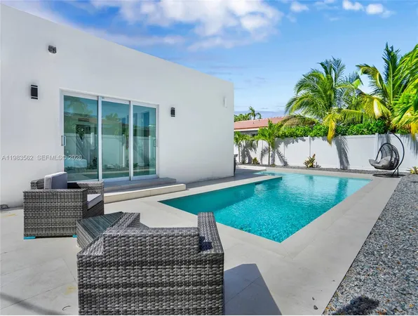 a view of a backyard with a slide and a wooden fence
