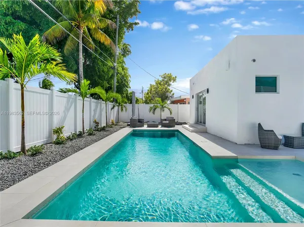 a swimming pool with outdoor seating and yard